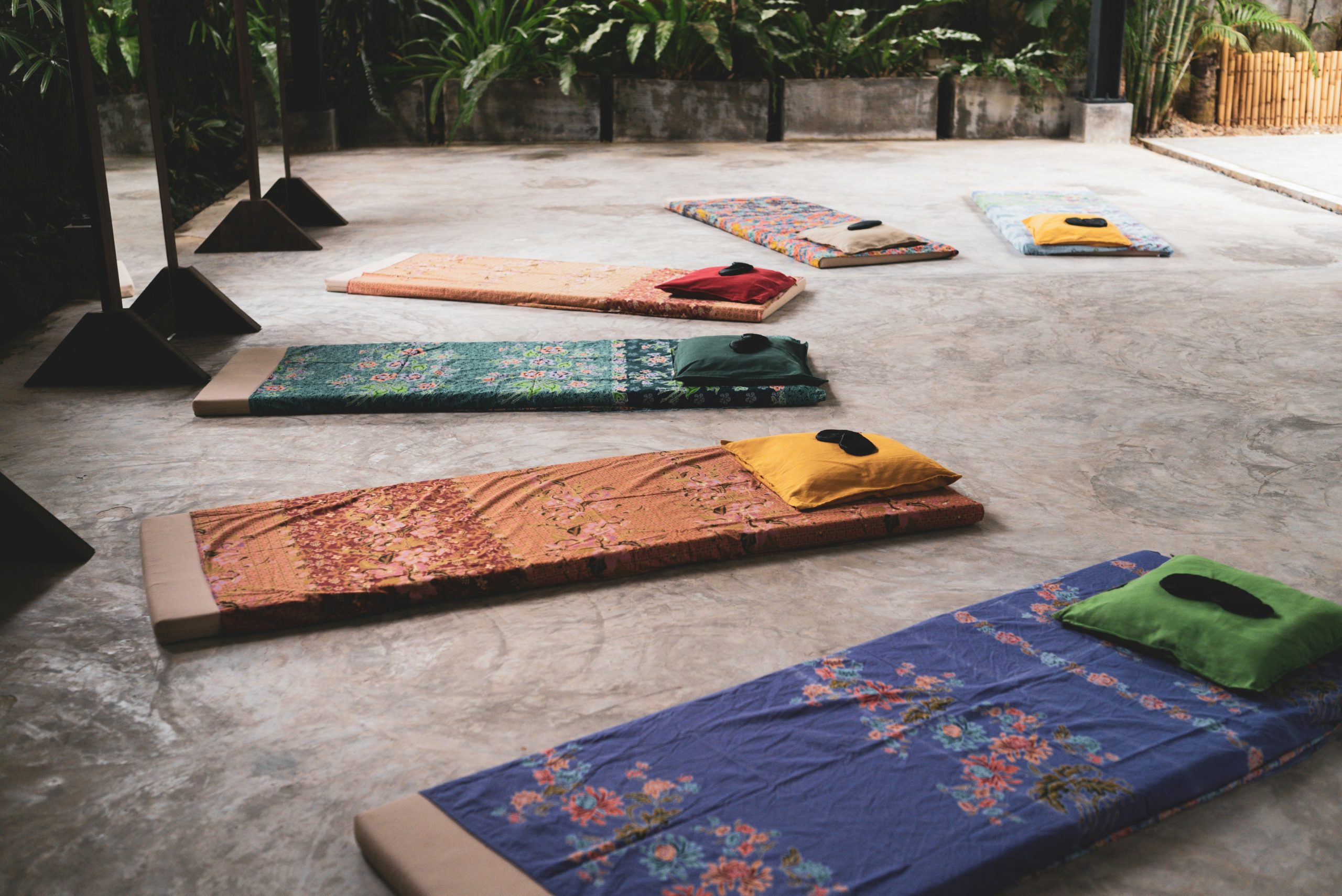 A group of people practicing Pilates in a studio with mats