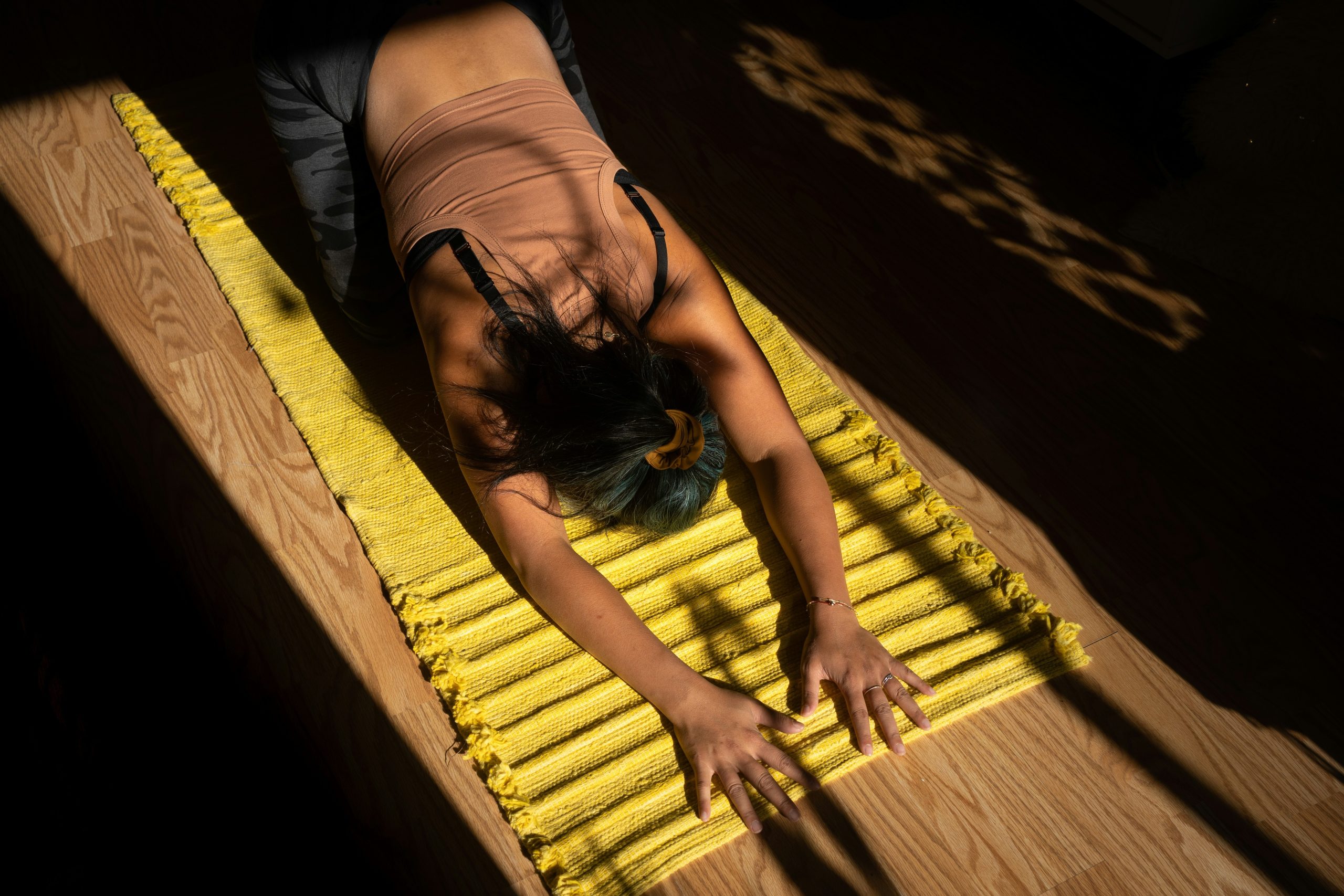 A woman demonstrating a Pilates core exercise on a mat