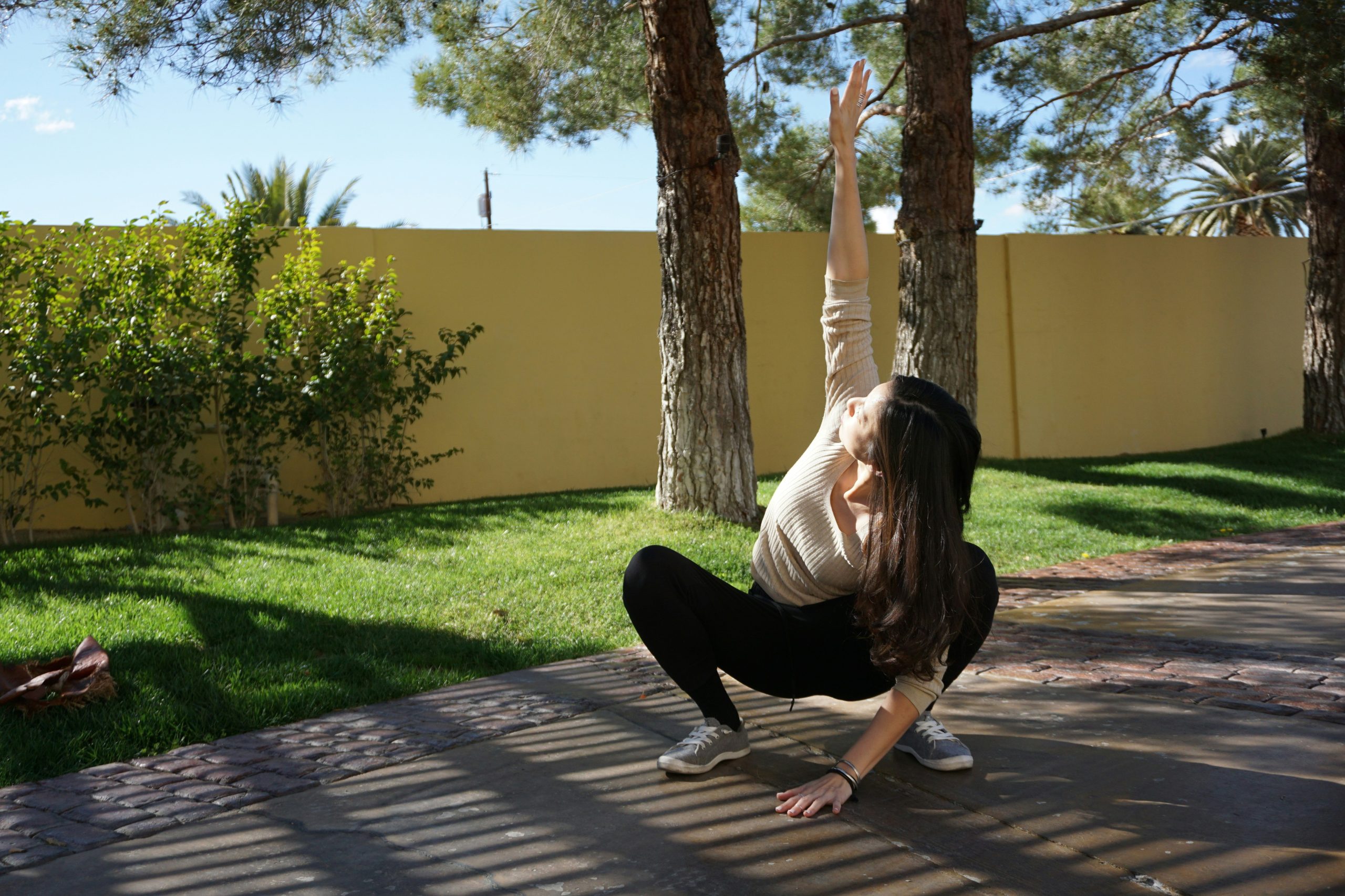 A woman stretching her hamstrings outdoors