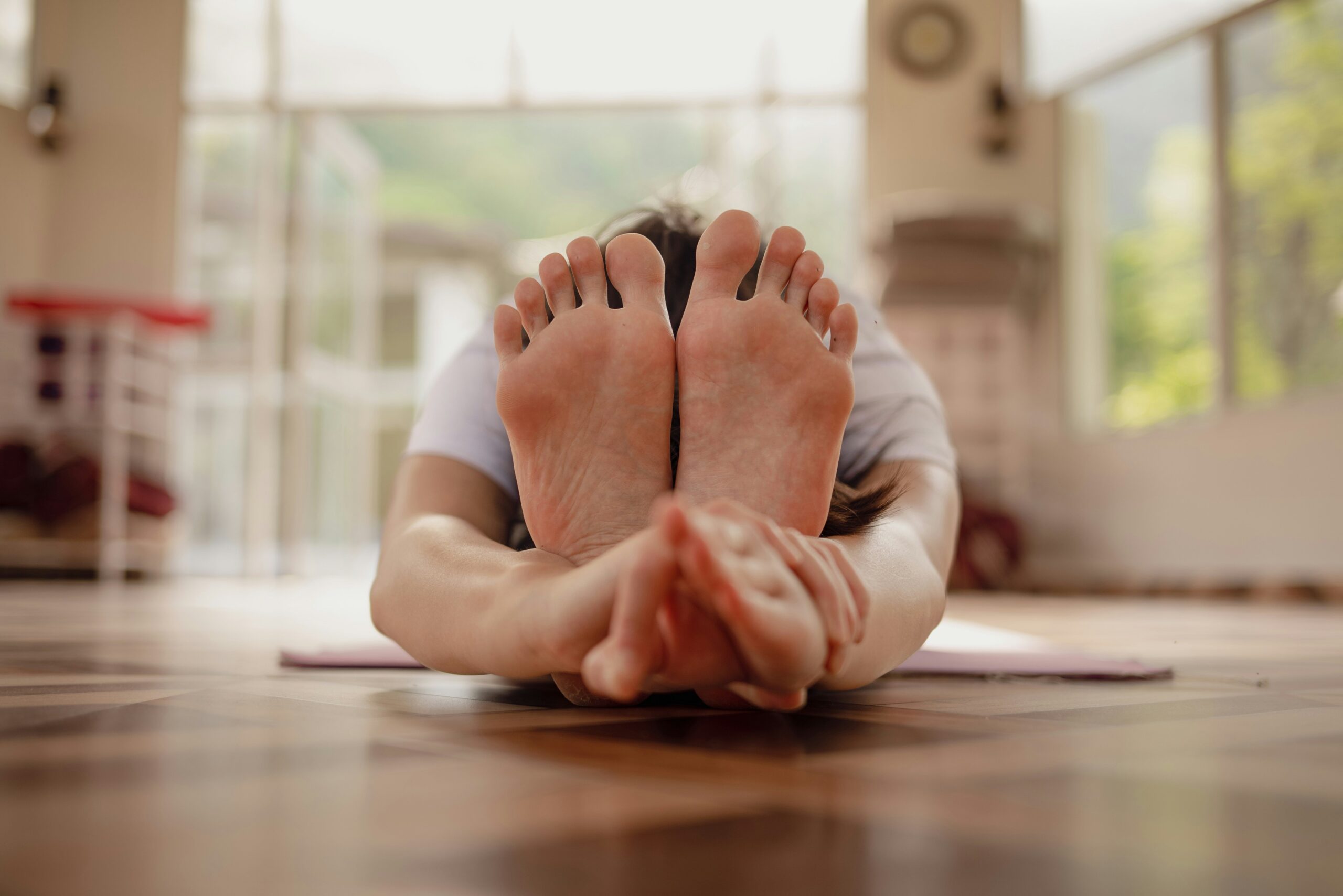 A woman demonstrating basic pilates positions on a mat