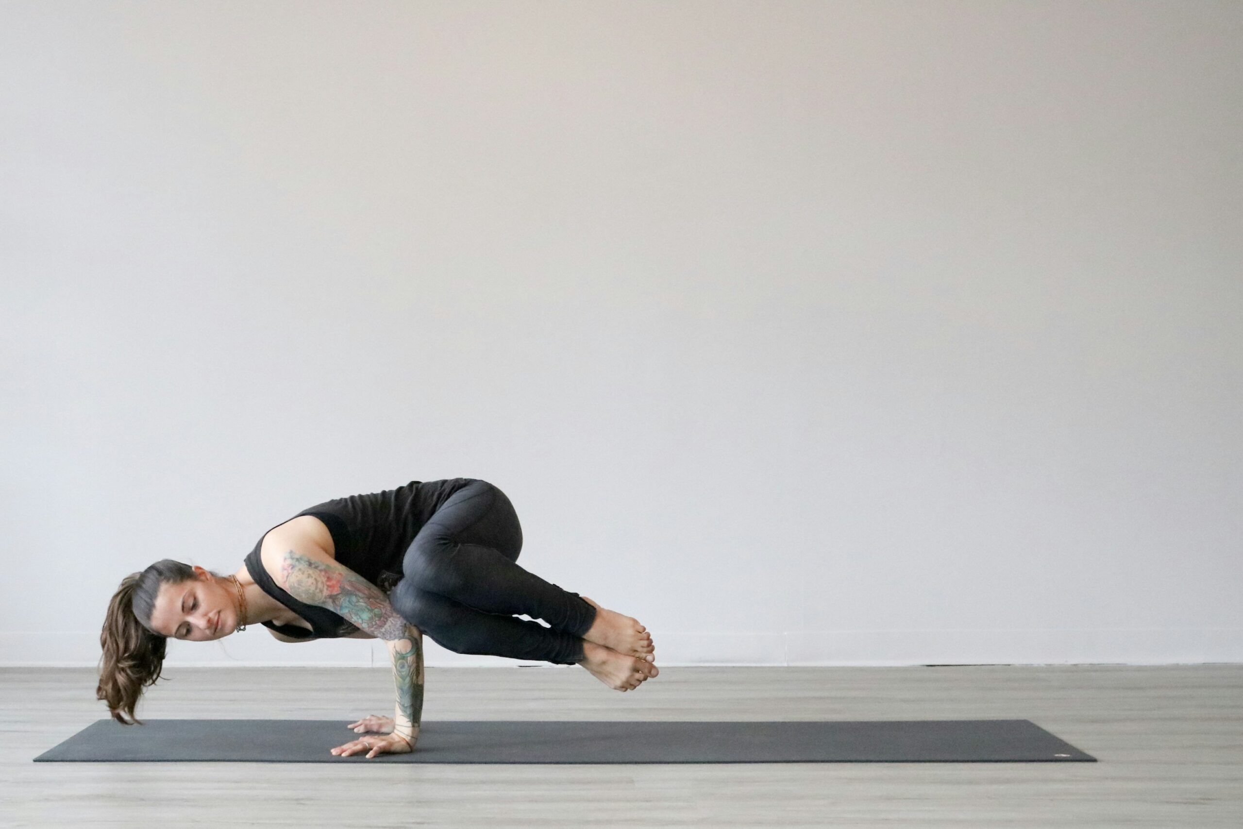 A woman performing Pilates core exercises