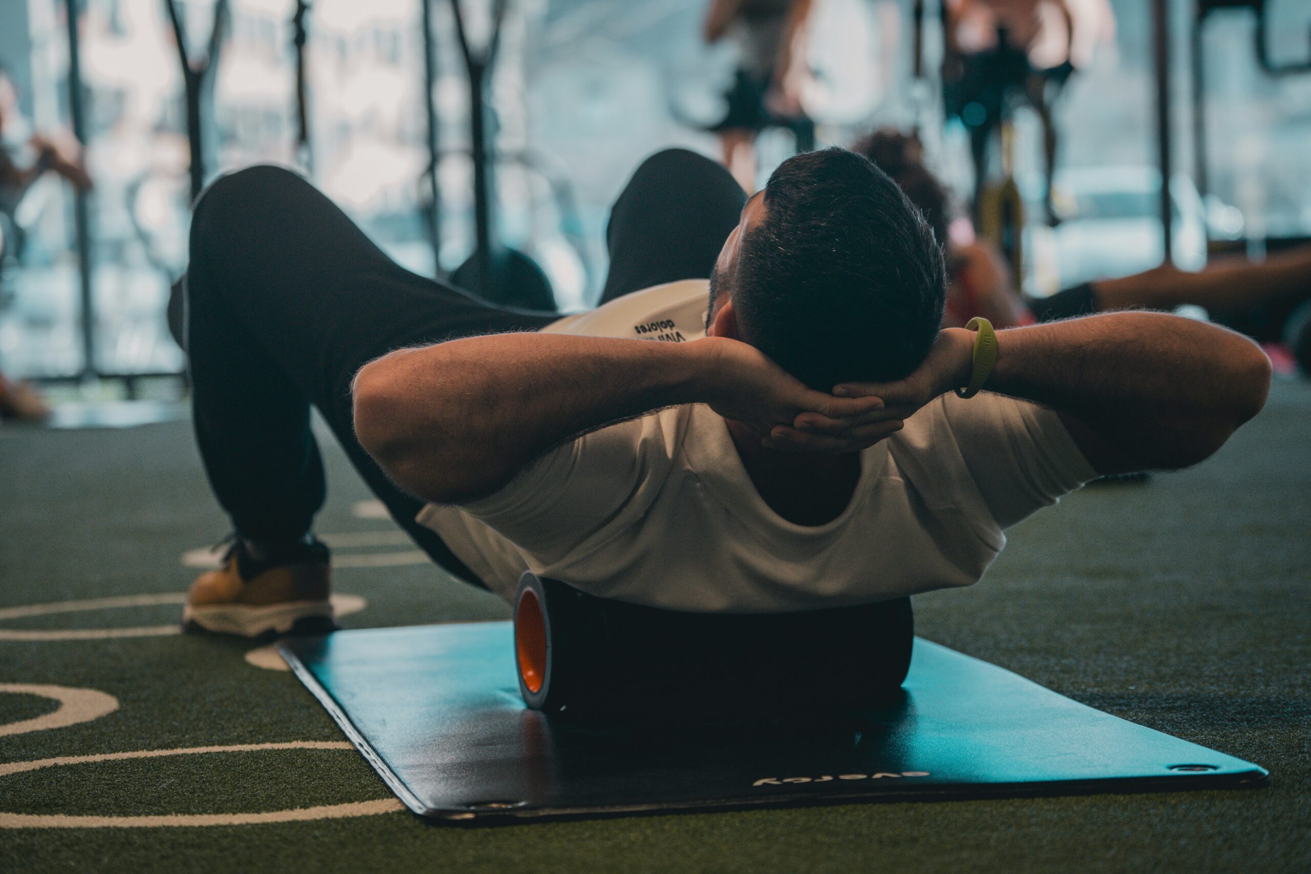 Collection of basic pilates tools including mat, band, and block against a clean backdrop