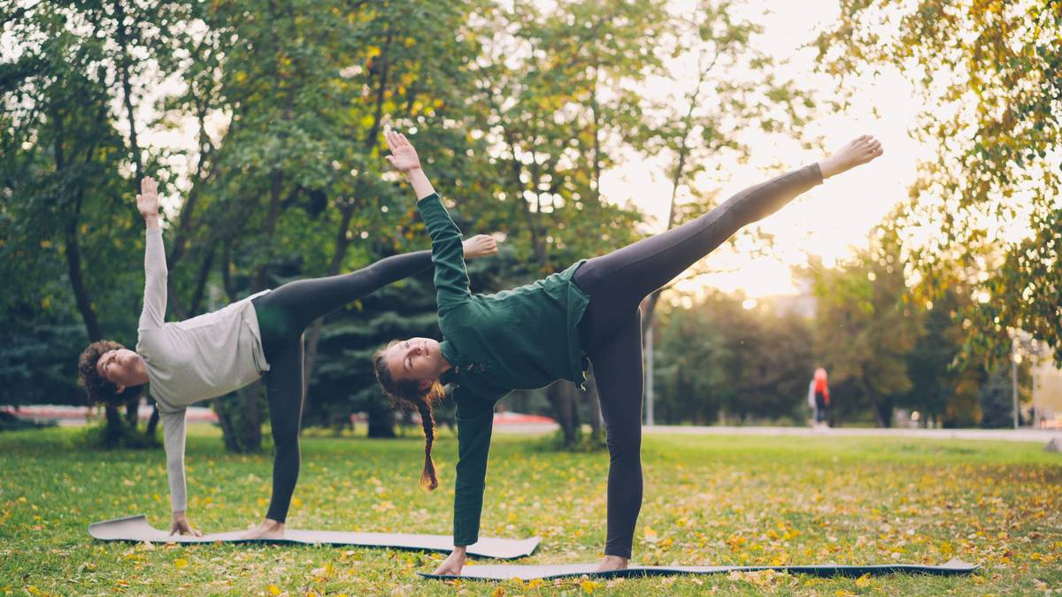 A woman performing a Pilates plank pose on a yoga mat.
