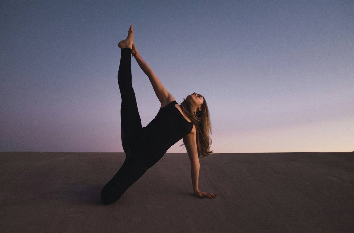 A woman performing basic Pilates moves on a mat.