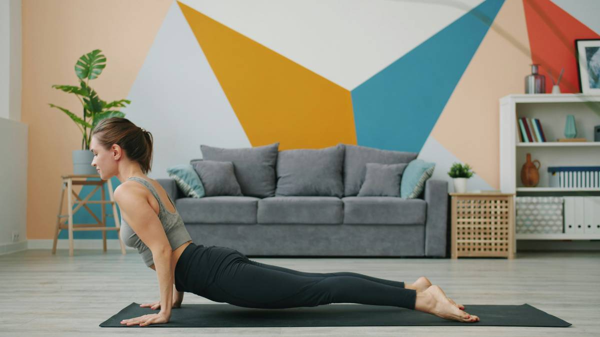 A person performing the Hundred pose in a pilates studio setting.
