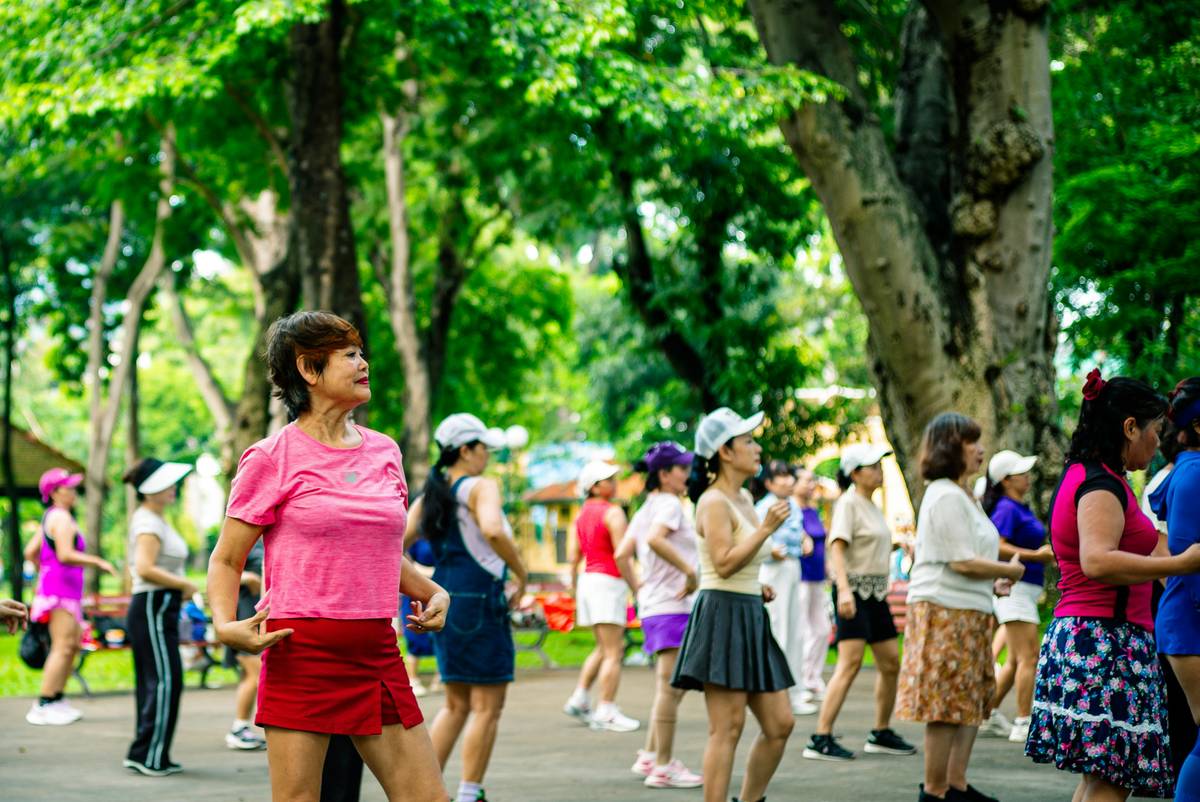 A woman performing a pilates flex move on a mat